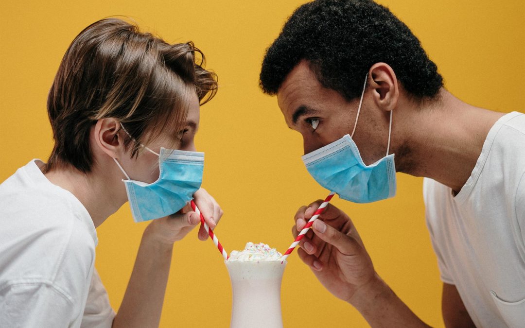couple with mask having a smoothie