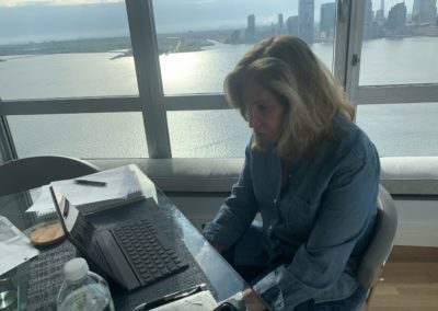 a photo of debra working on her laptop